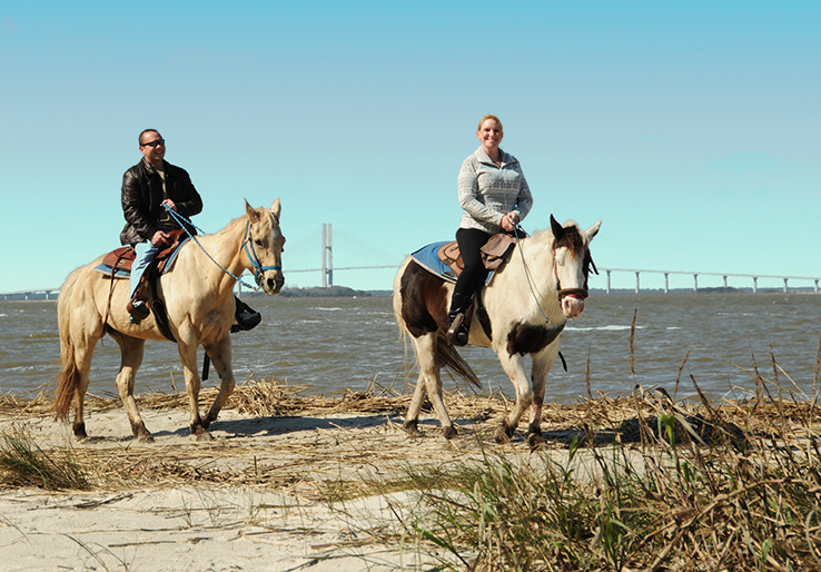 Two people riding horses on Jekyll Island.